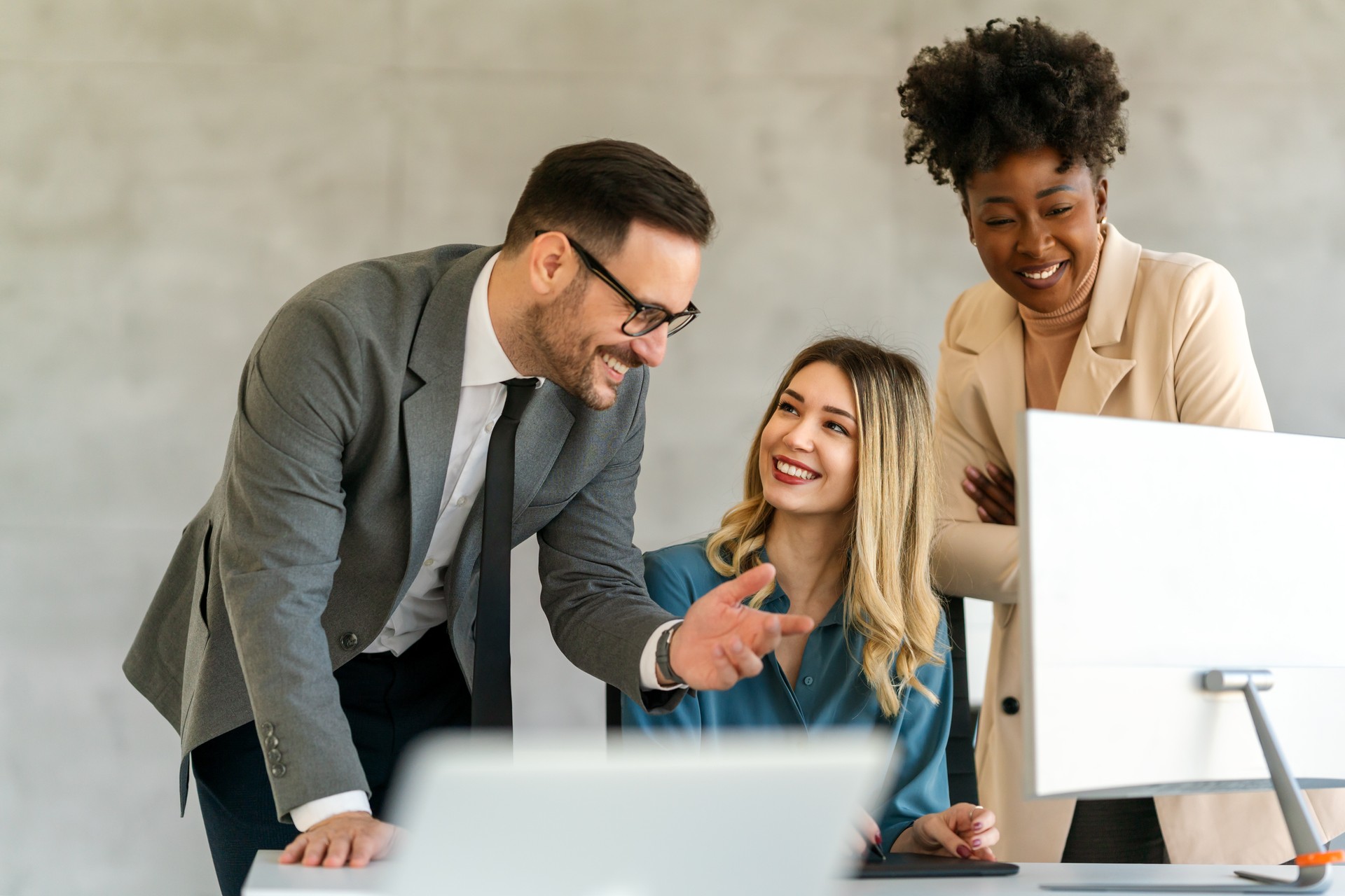 Group of multiethnic business people analyzing data using computer while working in the office